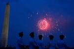 Members of the U.S. Army Band "Pershing's Own" watch fireworks at the end of a military parade commemorating the Army's 250th anniversary on Saturday in Washington, D.C.
