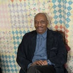 Jim Tharpe, shown here in an undated provided photo, poses in front of one of his great-great-grandmother's quilts. Tharpe is the current caretaker of the quilt collection, which encompasses more than 150 years of his family history.