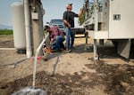 In this August 2021 file photo, pump servicers with TW Wells get a water well outside Klamath Falls running again. Hundreds of residential wells in Klamath County have run dry during the region's third year in a drought emergency.