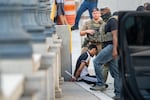 ICE and other federal agents take a delivery driver into custody at Union Station on August 16 in Washington, D.C.