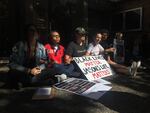 Protesters link arms outside the Campus Public Safety Division on Portland State University's campus Sept. 24, 2018.