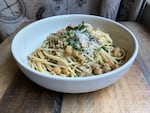 A bowl of spaghetti with garbanzos and sardines