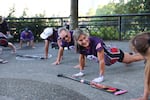 Tasha Teherani-Ami, of Portland, center, talks with Betsy Wilson of Milwaukie, right, during warm ups.