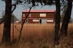Fire retardant covers the roof of a barn and truck .