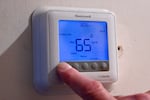 FILE - A thermostat indicating 65 degrees at a home in Bloomfield, Conn., Monday, Oct. 27, 2025.