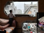 A child looks out at the rubble after an Israeli airstrike in Nuseirat refugee camp in central Gaza on May 20.