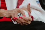 Maybelle Blair, 99 year old veteran of the All-American Girls Professional Baseball League - the last professional league in the US - grips a WPBL baseball prior to throwing out the first pitch at the inaugural WPBL game. Springfield, IL, August 1, 2026.
