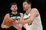 Denver Nuggets center Nikola Jokić looks to pass the ball during the second half of an NBA basketball game against the Portland Trail Blazers, Friday, Feb. 20, 2026, in Portland, Ore.