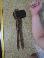 Matthew Decker shows the size of the ax for scale.