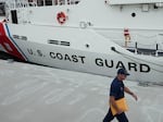 FILE - The U.S. Coast Guard Cutter Warren Deyampert is docked as a member of the Coast Guard walks past, Tuesday, June 20, 2023, at Coast Guard Base Boston, in Boston. Rescuers are racing against time to find the missing submersible carrying five people, who were reported overdue Sunday night, June 18, 2023. (AP Photo/Steven Senne, File)