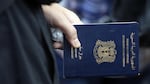 A Syrian refugee holds her passport at the Turkish Cilvegozu gate border,  Sept. 4, 2013.