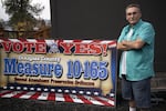 Tom McKirgan stands in front of his house with a campaign sign supporting the Douglas County Second Amendment Preservation Ordinance on Oct. 23, 2018 in Camas Valley, Oregon. McKirgan is a member of the Three Percenter militia and helped write the Douglas County ordinance.