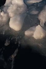 A piece of ice broken off from the iceberg floats in the ocean.