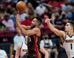 Portland Trail Blazers guard CJ McCollum shoots in front of Denver Nuggets forward Michael Porter Jr. during the second half of Game 6 of an NBA basketball first-round playoff series Thursday, June 3, 2021, in Portland, Ore.