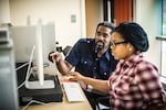 Professor Tewodross Melchishua Williams works with an Animation and Motion Graphics student at Bowie State University.