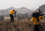 Journalists capture images of the Rowe Creek Complex Fire near Mitchell, Ore., on Tuesday, July 21, 2026.