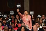 U.S. Rep. Nydia Velázquez, D-N.Y., holds a "Musk Steals" protest sign with fellow Democrats as Trump speaks during his address to Congress.