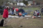 FILE: People clean up as the Peninsula Crossing trail homeless camp in Portland is swept. Feb. 8, 2023.
