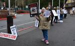 Volunteers with Free the Oregon Zoo Elephants protest Packy's memorial.