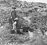 Chinese gold miners working a small stream