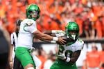 Oregon quarterback Dillon Gabriel (8) hands off the ball to running back Jordan James (20) during the first half of an NCAA football game, Saturday, Sept. 14, 2024, in Corvallis, Ore.