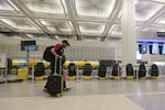 A traveler walks past covered Spirit Airlines kiosks, Saturday, May 2, 2026, at George Bush Intercontinental Airport, in Houston.