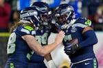 Seattle Seahawks linebacker Uchenna Nwosu, right, is congratulated by teammates after recovering a fumble and returning it for a touchdown during the second half of the NFL Super Bowl 60 football game against the New England Patriots, Sunday, Feb. 8, 2026, in Santa Clara, Calif. (AP Photo/Brynn Anderson)