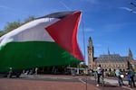 A Palestinian flag flies outside the International Court of Justice, which opened hearings into a United Nations request for an advisory opinion on Israel's obligations to allow humanitarian assistance in Gaza and the West Bank, in The Hague, Netherlands, Monday.