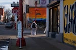 A person walks the intersection of Couch Street and Fourth Street in the Old Town neighborhood of Portland, Ore., on Monday, Jan. 12, 2026.