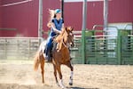 Morgan Young rides her horse Lena at the Benton County Fairgrounds as they prepare for the Benton County Larry Bell Memorial All Girls Rodeo on Tuesday, July 14, 2026.