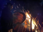 Yatsu-Ats “Joe” McCloud sings and drums by the bonfire at the Nisqually Culture Center during the Winter Moon Celebration on Winter Solstice.