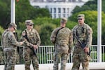 With the White House in the distance, National Guard troops patrol the Mall as part of President Donald Trump's order to impose federal law enforcement in the nation's capital, in Washington, Aug. 28, 2025.