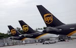 The tails of three UPS aircraft are shown parked at Miami International Airport in Miami in 2020. Some UPS and FedEx planes are grounded after a UPS plane crashed.