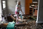 Stedi Scuderi looks over her apartment in Fort Myers, Fla., on Sept. 29, 2022, after floodwater inundated it when Hurricane Ian passed through the area a day earlier.