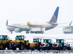 A United Airlines flight is de-iced before takeoff during a winter storm at Denver International Airport on Wednesday in Denver.