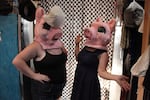 Helen's Pacific Costumers Manager Sally Newman, right, and her roommate, left, model two of the "Three Little Pigs" mascot heads.