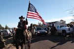 A procession of men and women on horseback escorted the hearse away from the church.