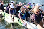 (Left to right) Eric Gross, Steve Schuitevoerder and Cindi Coleman paddle during training.