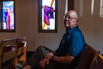 The Rev. Steve Sylvester sits in a pew at the church. 