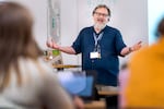 Don Gavitte teaches a U.S. government class at Grant High School, on Oct. 3, 2023, in Portland, Ore., often using dry humor to engage students. Gavitte is the creator of "The Teacher Show: Comedy from the Classroom," a stand-up comedy showcase performed by educators.