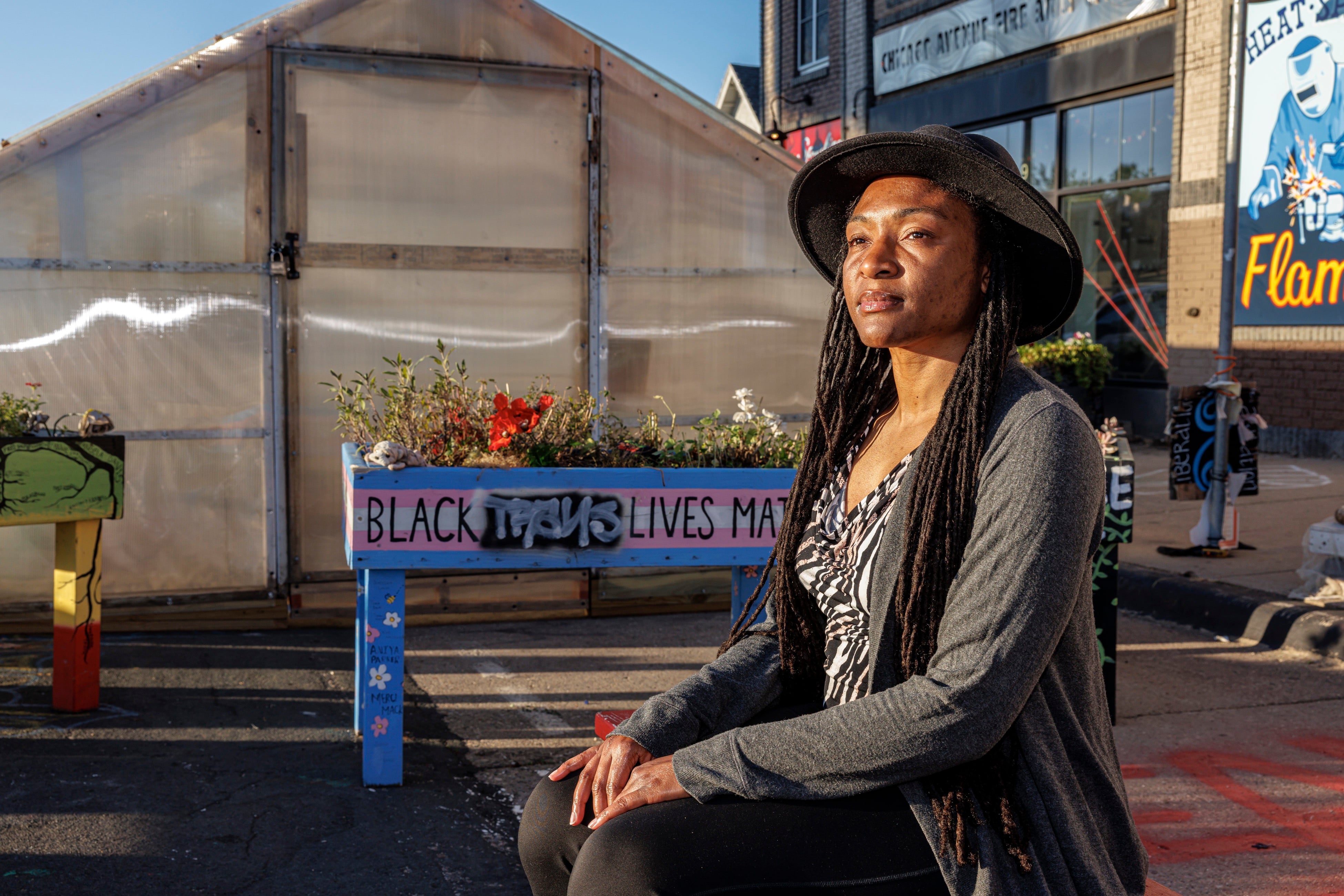 Jeanelle Austin, who leads the racial justice group Rise and Remember, sits outside the greenhouse set up at George Floyd Square.