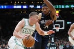 Boston Celtics' Payton Pritchard (11) drives past Orlando Magic's Wendell Carter Jr. during the first half in game 1 of a first-round NBA playoff basketball series Sunday, April 20, 2025, in Boston. (AP Photo/Michael Dwyer)