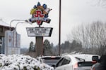 A sign seeking workers is displayed at a fast food restaurant in Portland, Ore., Monday, Dec. 27, 2021.