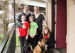 Ken "Tank" Dunham and his wife Britney, pose with their children 10-year-old Talin, 8-year-old AndaKiss 12-year-old Kenny and their dog Lucy outside the door of their motel suite.