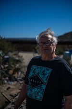 Jaroslav "Jerry" Shuster stands for a portrait above Moon Camp, which largely rests on his private land just outside of Jacumba, Calif.