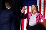 Eric Trump and his wife, Republican National Committee Co-Chair Lara Trump high-five during a rally for former President Donald Trump in Reading, Pa., on Monday.