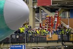 Employees watch a Boeing 747 during an event at the company's facility in Everett, Wash., on Tuesday.