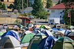 Fire crew tents line a campsite at the Burdoin Fire Incident Command Post at Henkle Middle School in White Salmon, Wash., July 24, 2025.