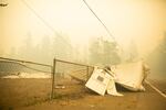 The incident command center for the Santiam Fire topples onto the road near Gates, Ore., Sept. 9, 2020.