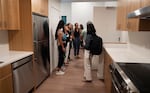 People tour a unit at Legin Commons on Sept. 10, 2026 in Portland, Ore.